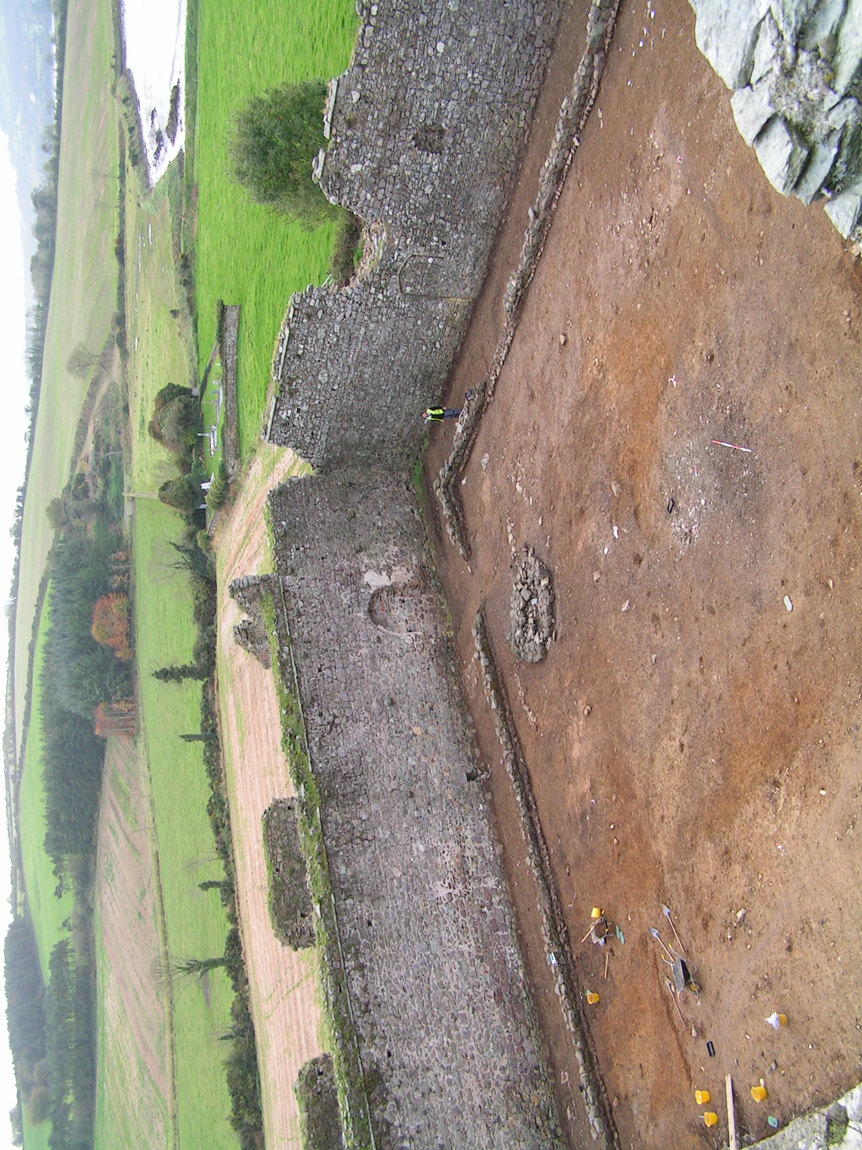 The cloister garth under excavation; the circular lavabo can be seen beside the walkway