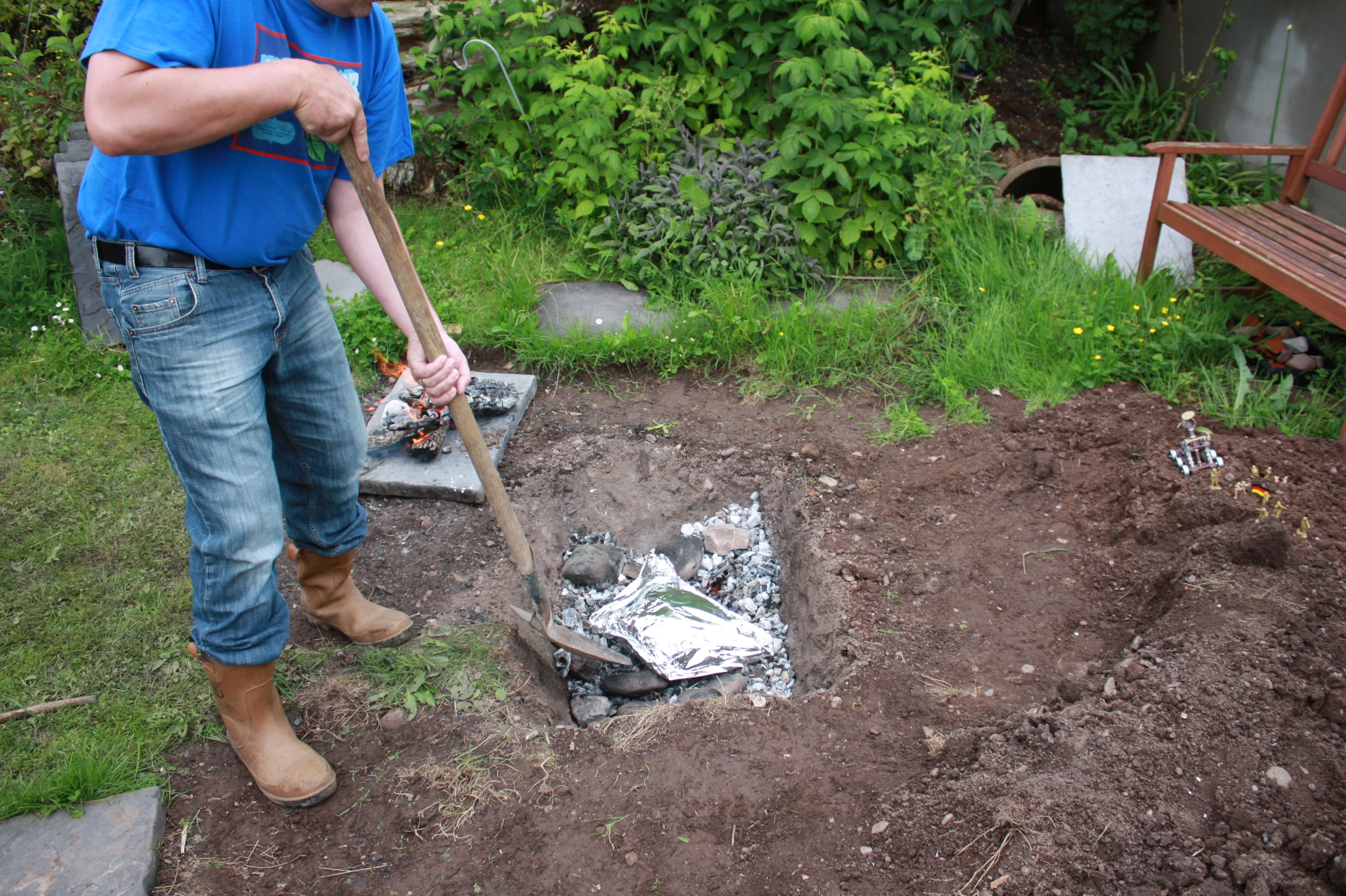 Stage 6: Place the meat into the hot coals and surround it with hot stone and charcoal