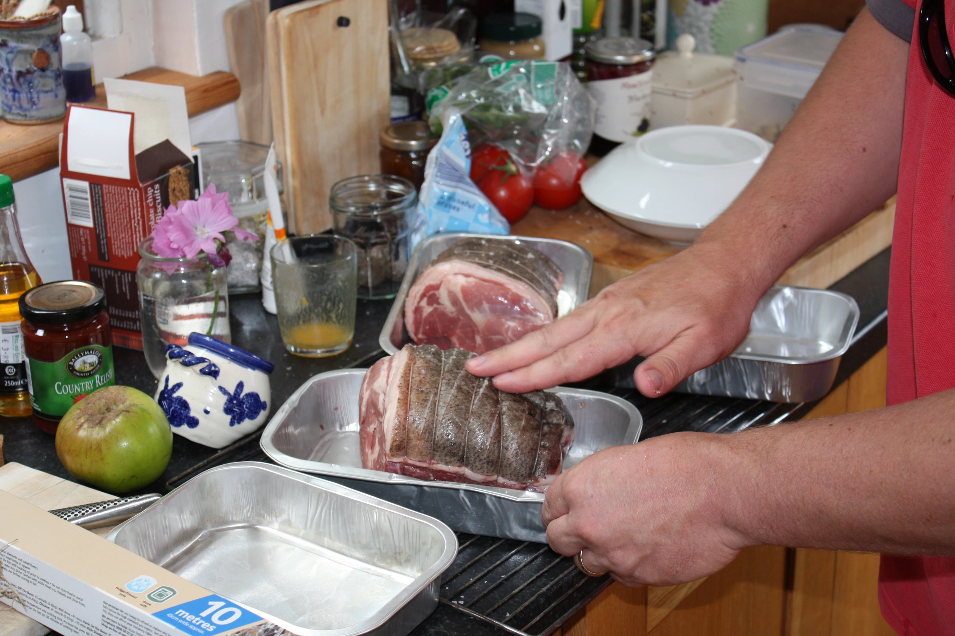 Porky is prepped by scoring the skin and seasoning