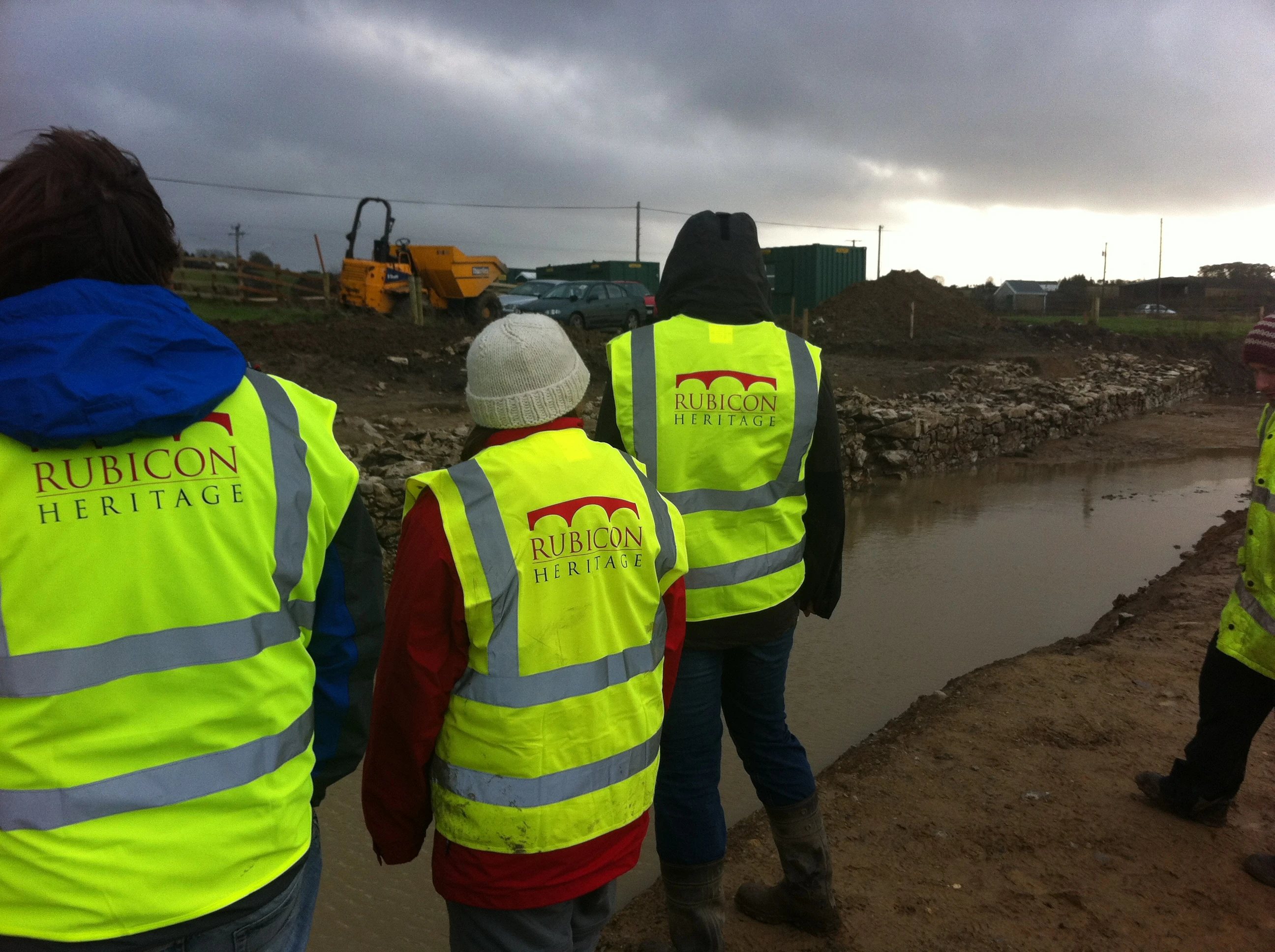 The team gaze nervously over the water-filled moat and revetment