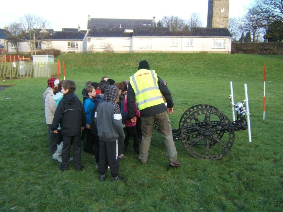 The pupils of St. Ninian's Primary School are shown how the Rubicon geophysics cart operates