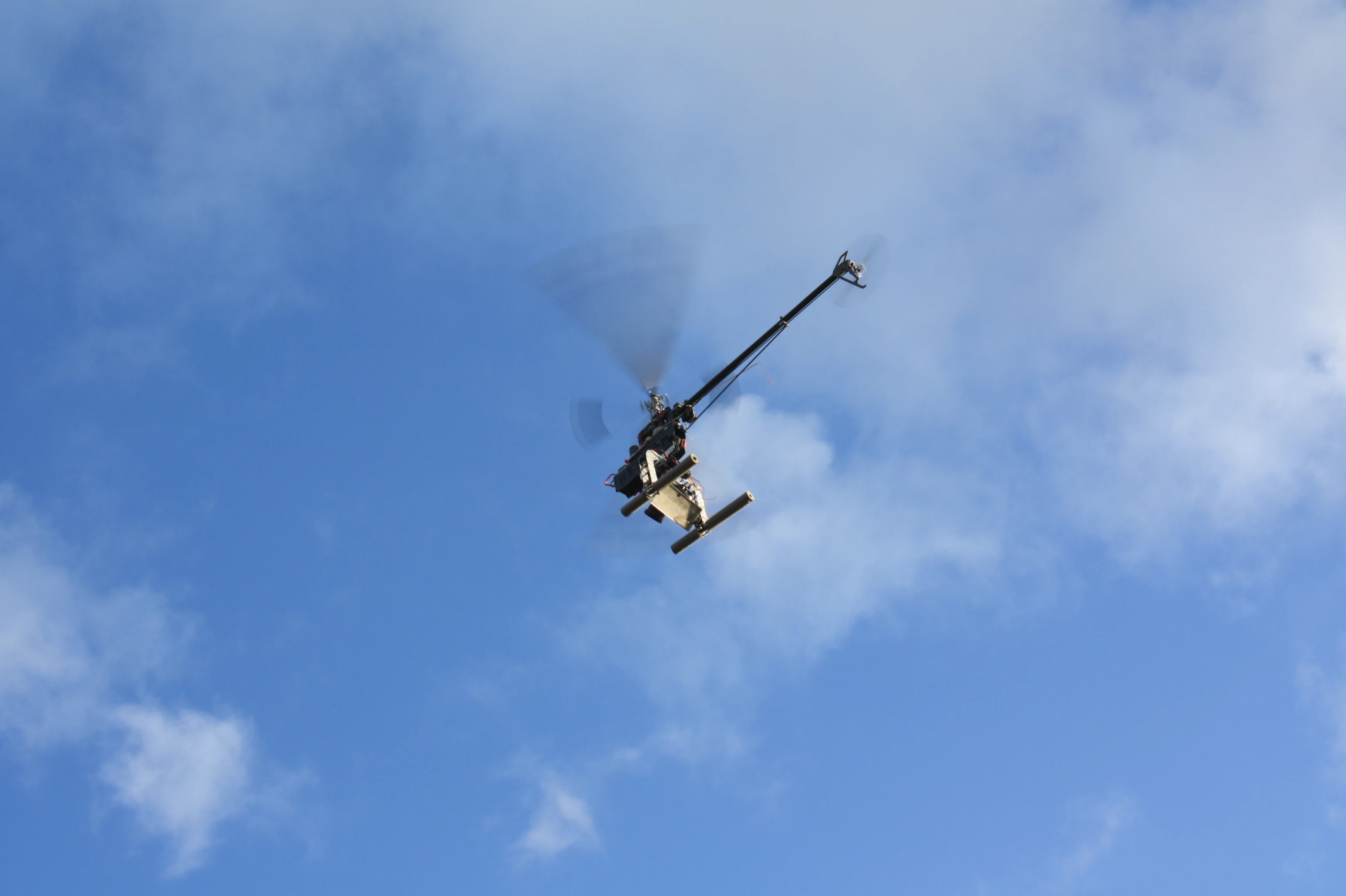 The remote control helicopter in action over the site